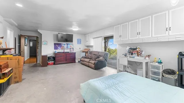 a bedroom with furniture and a flat screen tv