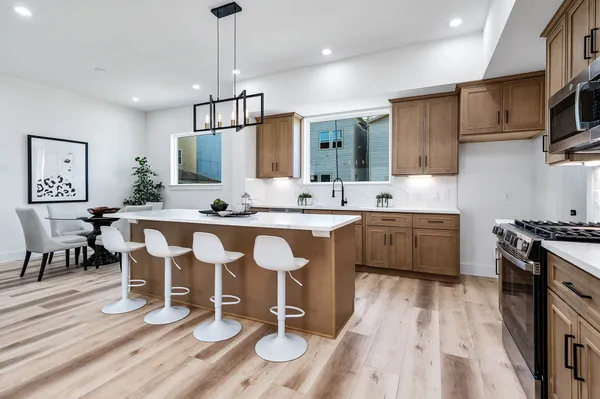 a kitchen with a dining table chairs and kitchen view