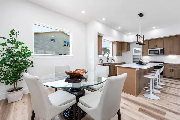 a kitchen with kitchen island a counter space a sink appliances and cabinets