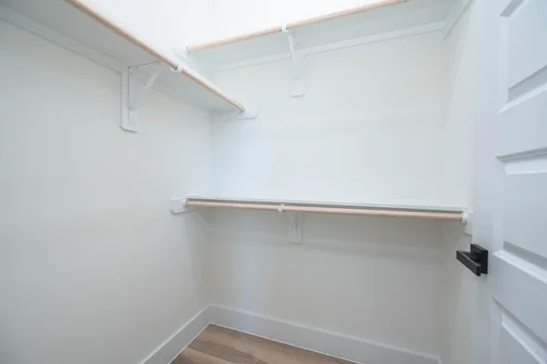 a spacious bathroom with a double vanity sink a mirror a bathtub and a shower