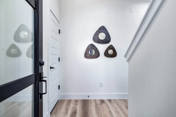 a view of an entryway with wooden floor and staircase