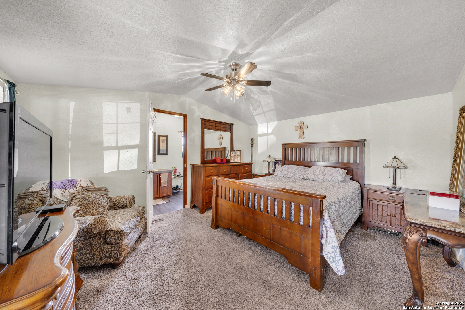 11706-11791 Kinney Road Atascosa, TX 78002 - Photo 31 of 35 a bedroom with a bed and a chandelier