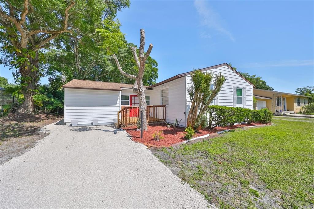 5117 North Rome Avenue Tampa, FL 33603 - Photo 1 of 9 a front view of a house with garden