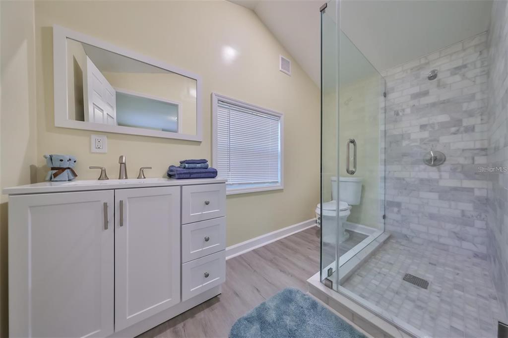 5117 North Rome Avenue Tampa, FL 33603 - Photo 2 of 9 a bathroom with a shower sink and mirror