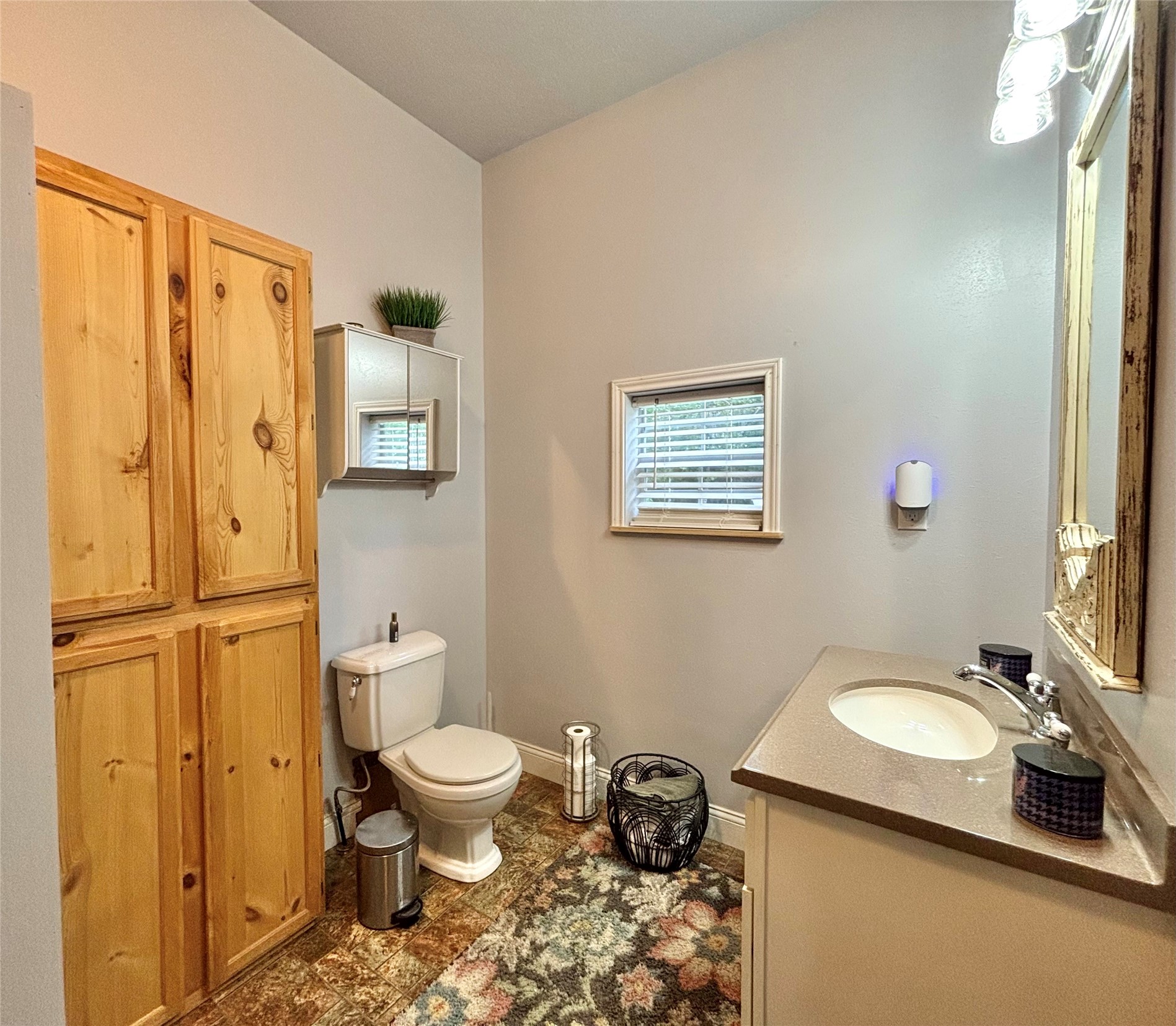 516 County Road 4800 Warren, TX 77664 - Photo 21 of 50 a bathroom with a granite countertop toilet sink and mirror