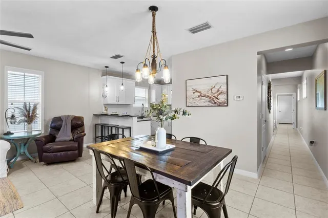 a view of a dining room with furniture and chandelier