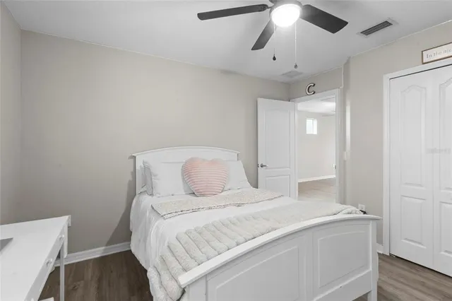 a spacious bedroom with a bed and a chandelier