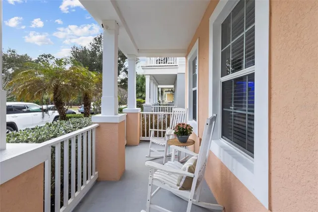 a view of a chair and tables in the balcony