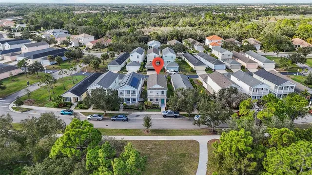 an aerial view of residential houses with outdoor space and swimming pool