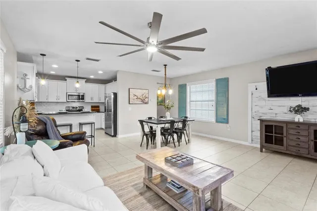 a living room with furniture a dining table and a fireplace