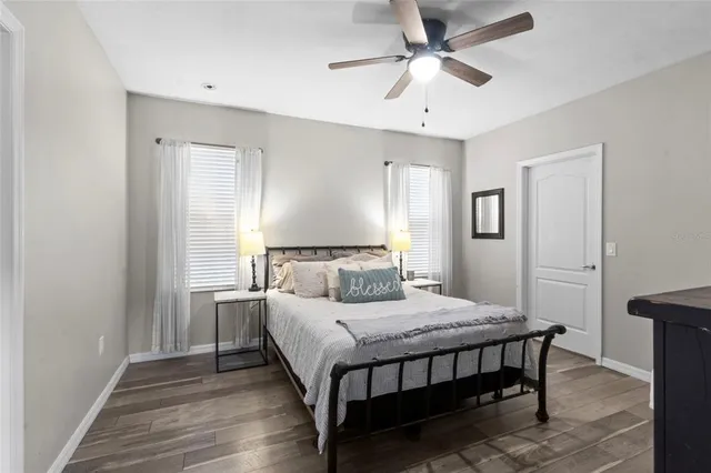 a bedroom with a bed and a chandelier