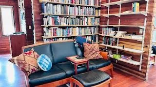 a room with bookshelf and a couch