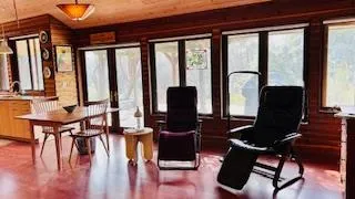 a view of a livingroom with furniture and floor to ceiling window