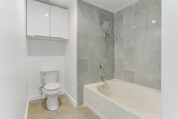 a bathroom with a toilet and a bathtub