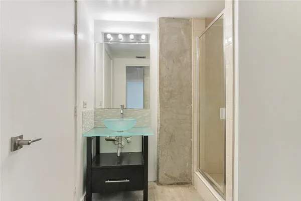 a bathroom with a toilet a sink and shower