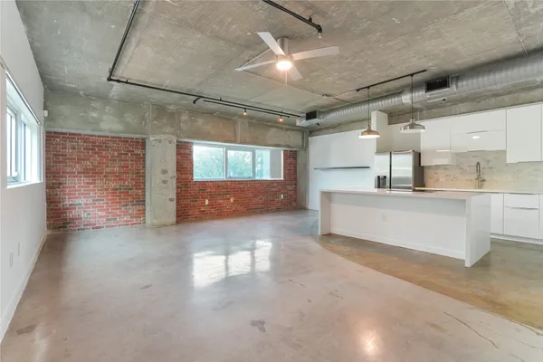 a view of kitchen with refrigerator and window
