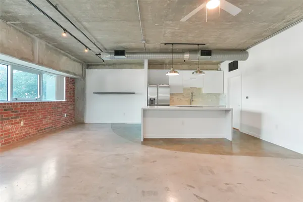 a kitchen with a refrigerator a sink and cabinets