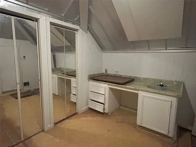 a kitchen with white cabinets and white appliances