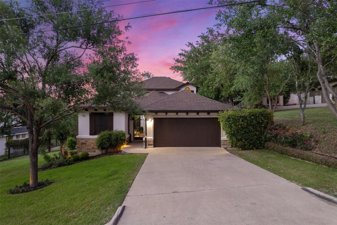 a front view of house with yard and green space