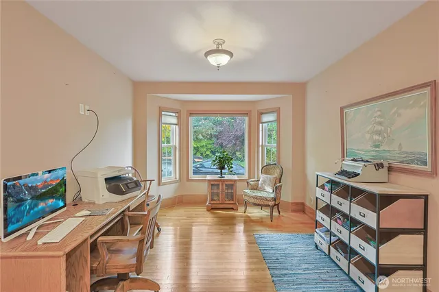 a living room with furniture a flat screen tv and a floor to ceiling window