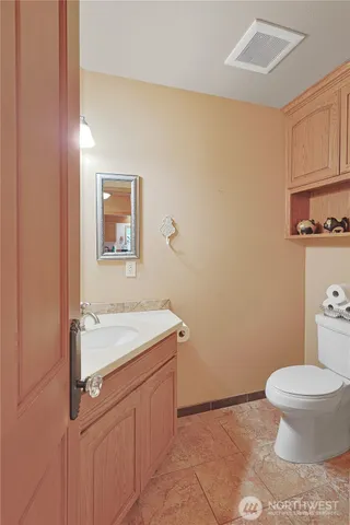 a bathroom with a sink a toilet and vanity
