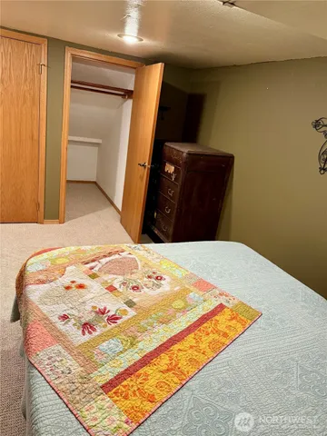 a bedroom with a bed and dresser