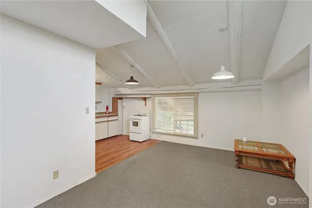 a kitchen with a refrigerator and white cabinets
