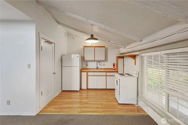 a bathroom with a toilet sink vanity and mirror