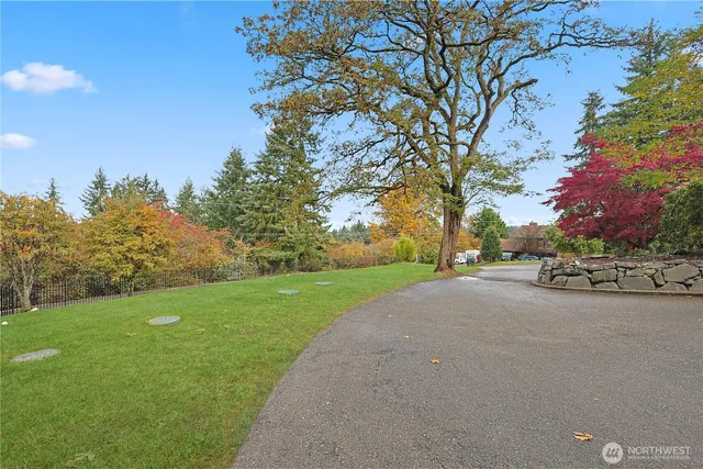 a view of a street with a house in the background