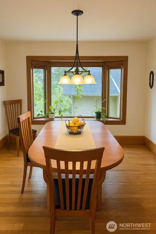 a view of a dining room with furniture window and wooden floor