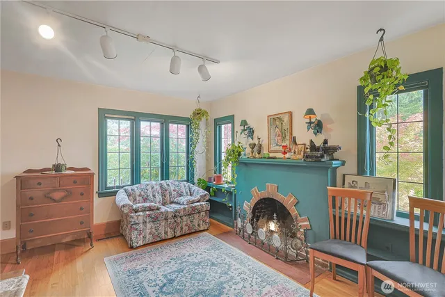 a living room with furniture a fireplace and a floor to ceiling window