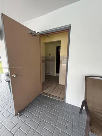 a view of a hallway to rooms and stairs