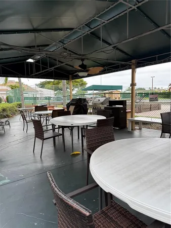 a roof deck with a table and chairs