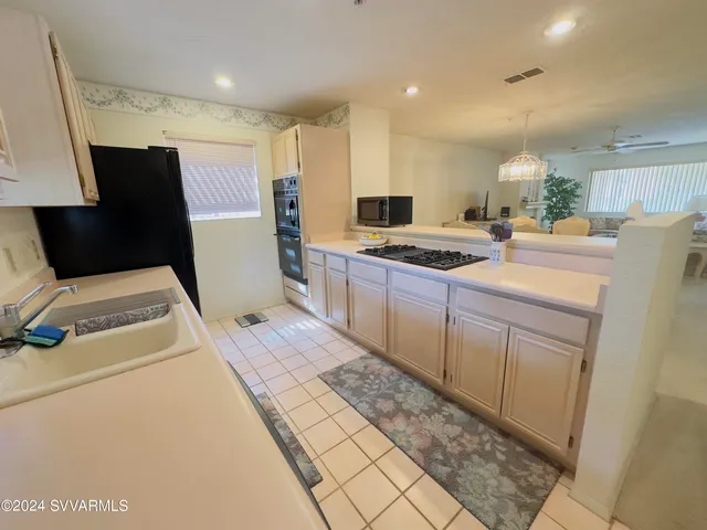 a kitchen with a stove sink and a refrigerator