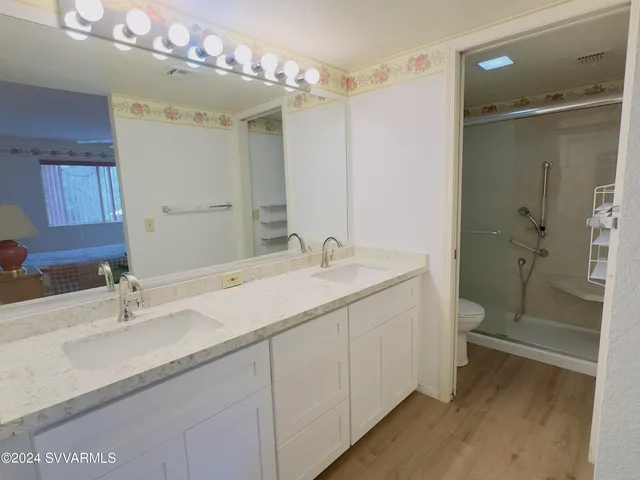 a bathroom with a double vanity sink mirror double and shower