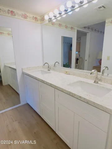 a en suite bathroom with a sink and a mirror