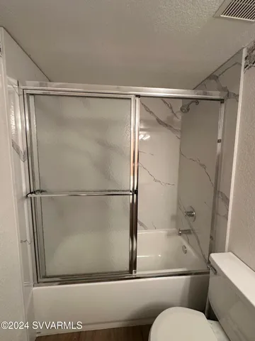 a bathroom with a glass shower door