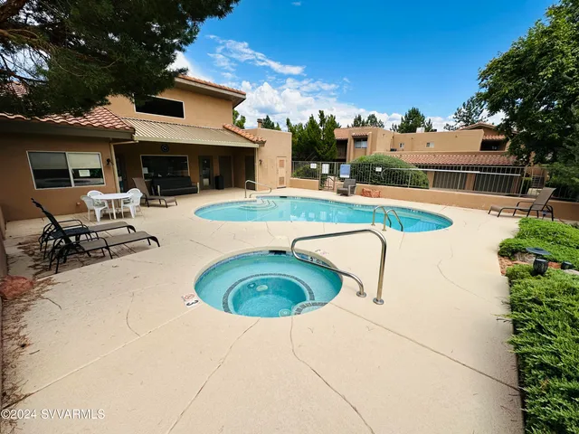 a view of a house with swimming pool and sitting area