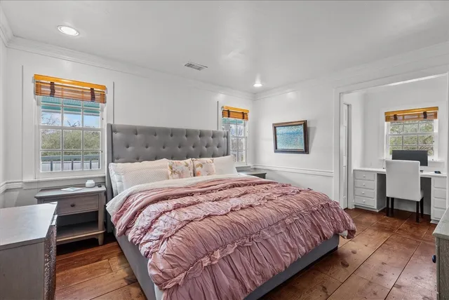 a bedroom with a large bed and a window