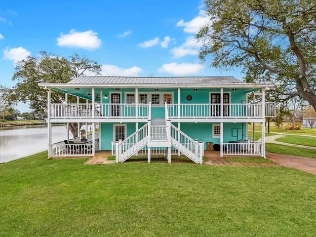 a view of a house with a backyard and a patio