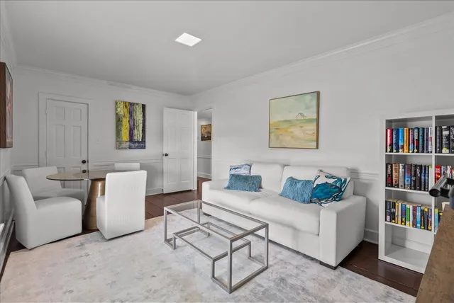 a living room with furniture and a book shelf
