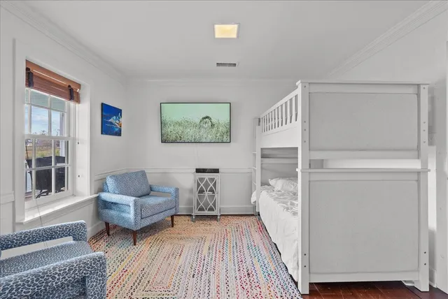 a view of a bedroom with furniture and wooden floor