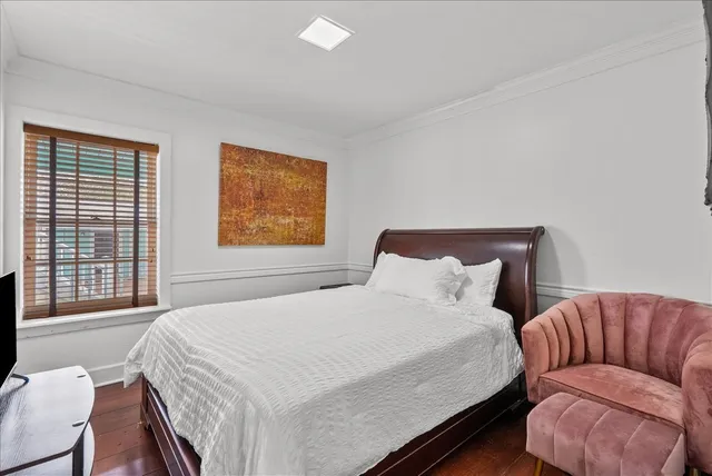 a bedroom with a large bed and a couch