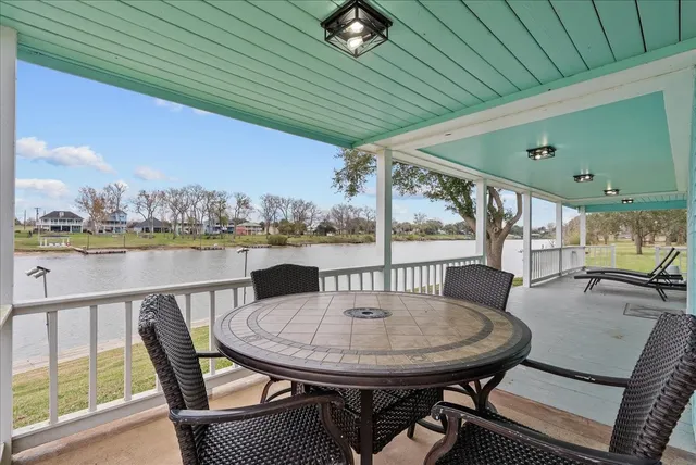 a view of a balcony with table and chairs