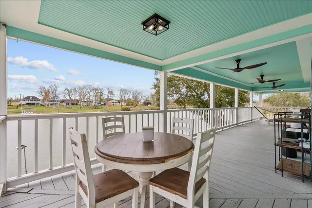 a balcony with table and chairs