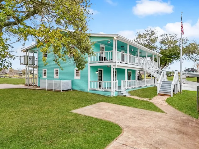 a front view of a house with a garden and yard