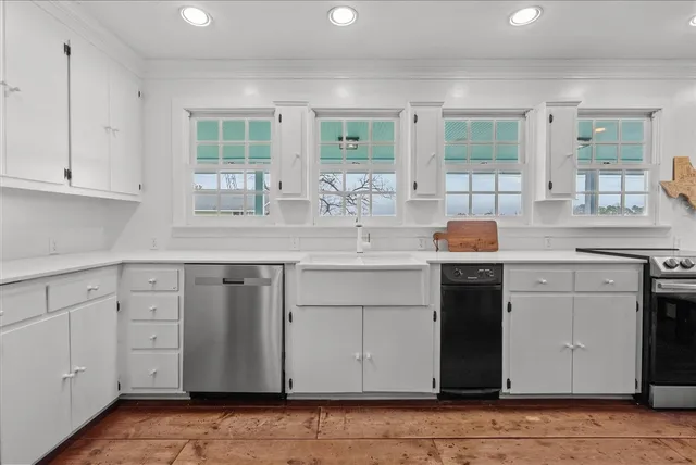 a kitchen with granite countertop cabinets stainless steel appliances a sink and a window