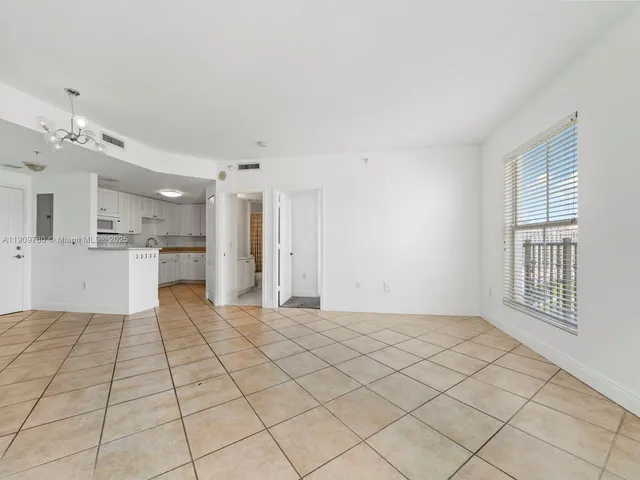 a view of a kitchen with microwave and refrigerator