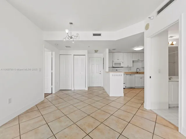 a kitchen with kitchen island granite countertop appliances cabinets and a sink
