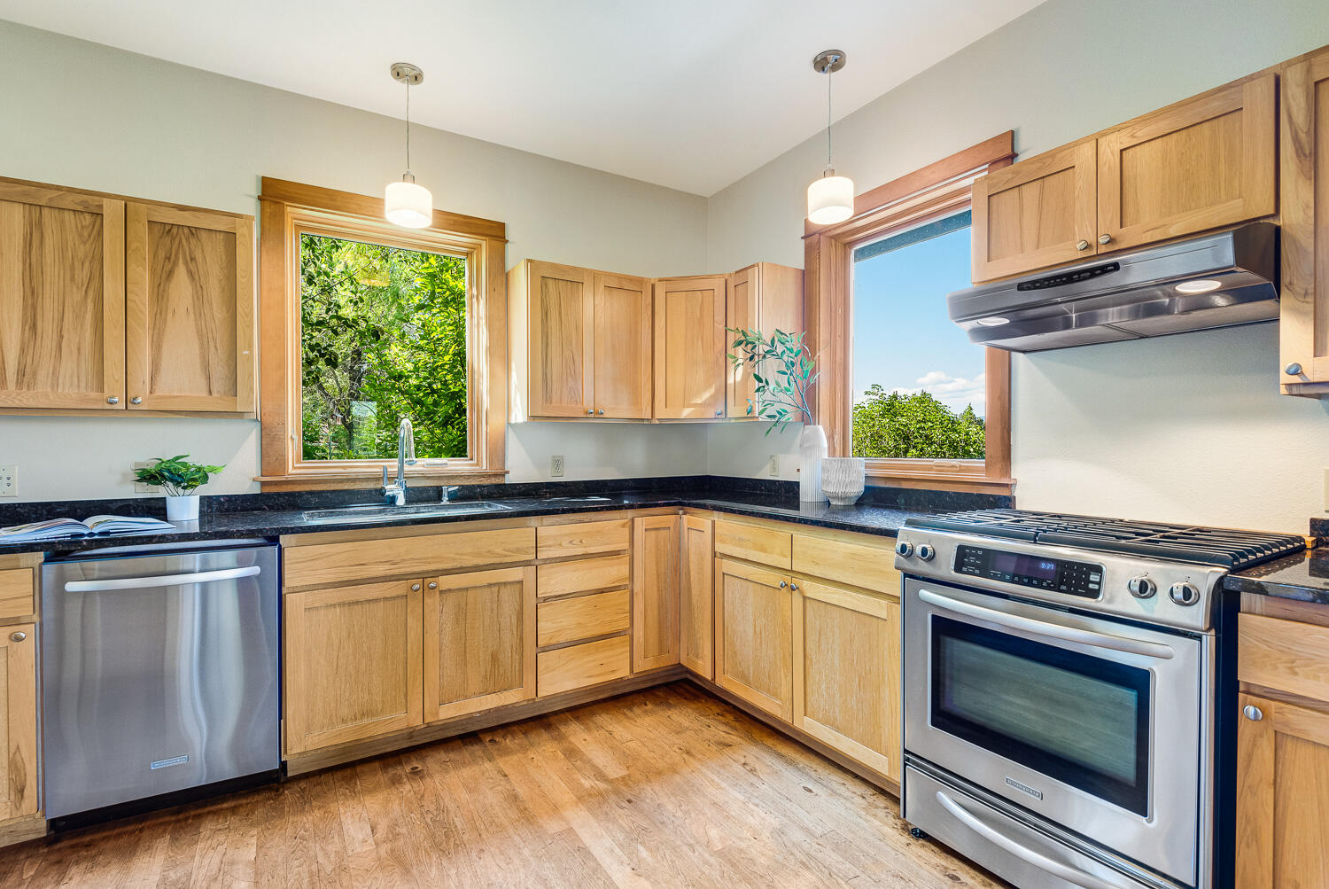 19007 Innes Market Road Bend, OR 97703 - Photo 10 of 39 a kitchen with stainless steel appliances granite countertop a stove a sink and a microwave